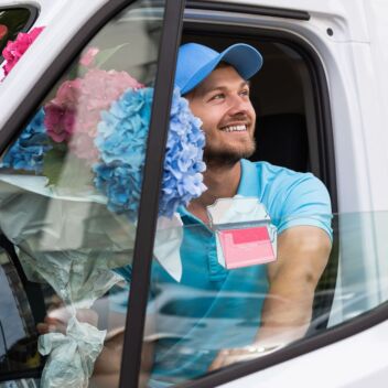 Business card holder clipped onto a florist van window