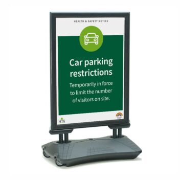Water filled base pavement sign displaying car parking restrictions in a store car park
